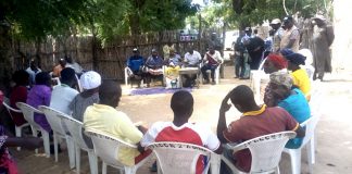 Mrs Yelwa sitting in the Middle of two men as one of the Executive of VSLA Pro-Act project in Dumne Community of Adamawa State